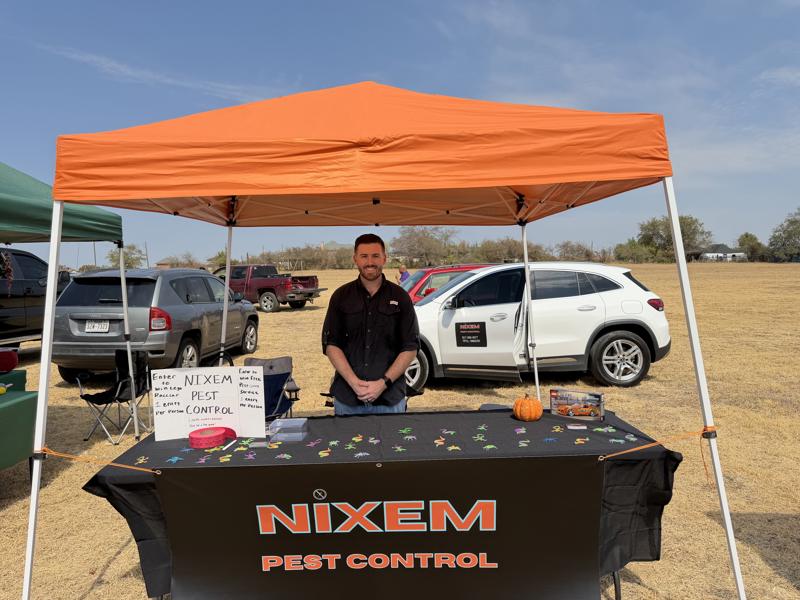 Nixem Pest Control booth at an outdoor community event